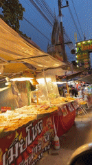 Evening street food market operates in Ban Tai, Thailand