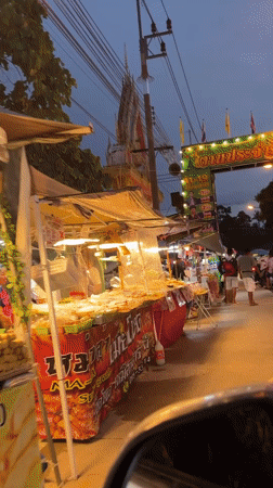 Evening street food market operates in Ban Tai, Thailand