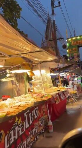 Evening street food market operates in Ban Tai, Thailand