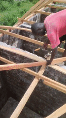 Construction worker builds roof structure in Agbarha-Otor, Nigeria