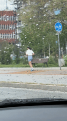 Rainy day scenes captured across Bulgaria showing traffic, jogger, classroom