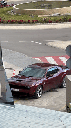 Dodge Challenger parked with traffic cone in Montenegro village