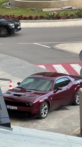 Dodge Challenger parked with traffic cone in Montenegro village