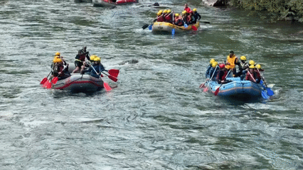 Groups Navigate Whitewater Rapids in Multiple Rafts During Morning