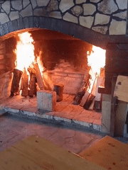 Roaring fire in a stone fireplace, Konush, Bulgaria
