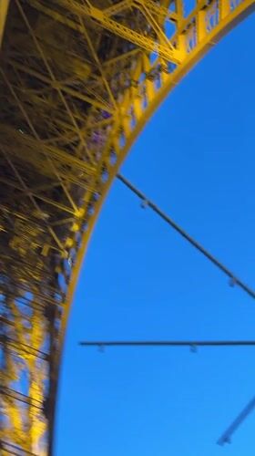 Fireworks illuminate golden Eiffel Tower in Paris evening display