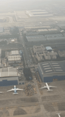 Airplane passenger films hazy industrial landscape in Guangzhou