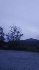 Vans parked at Old Long Hill against a bleak Irish landscape