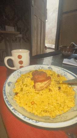 Man enjoys fried rice meal in Badagry, Nigeria