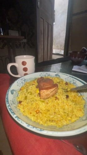 Man enjoys fried rice meal in Badagry, Nigeria