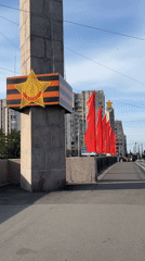 Red flags flutter along Saint Petersburg bridge pathway