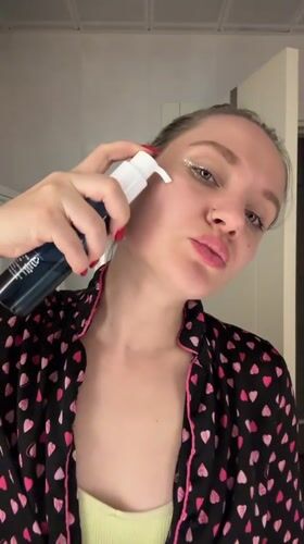 Woman performs evening skincare routine in Esenyurt bathroom