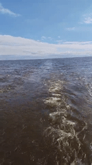 Vessel creates wake while crossing Russian waters