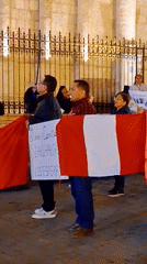 Protesters gather at Arequipa cathedral with political signs