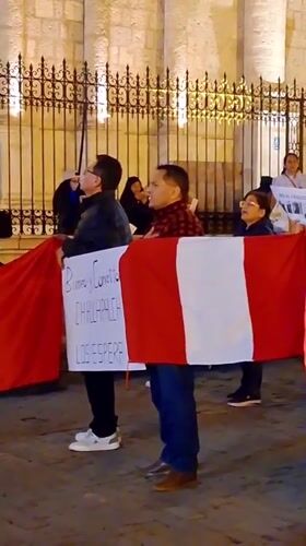 Protesters gather at Arequipa cathedral with political signs