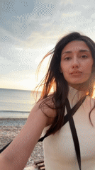 Woman captures sunset selfies at Montenegro beach with local wildlife