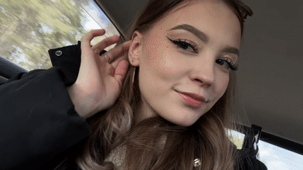 Woman poses for camera in car passenger seat, Yakutsk