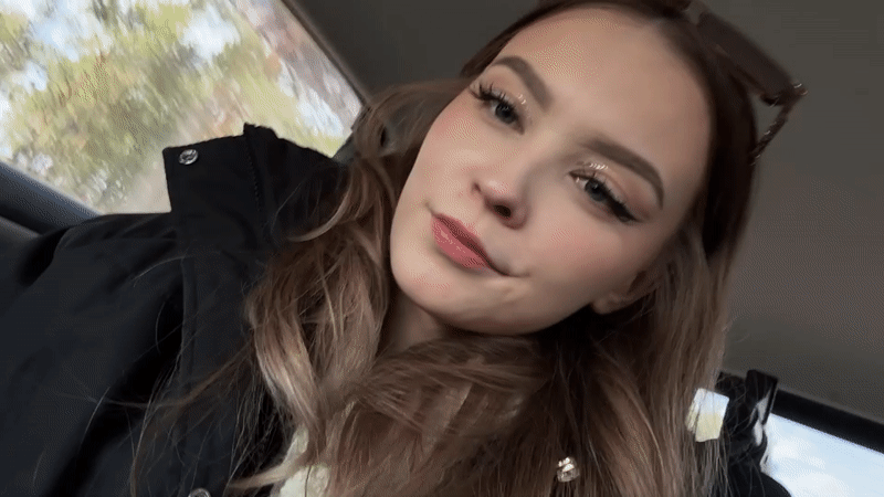 Woman poses for camera in car passenger seat, Yakutsk