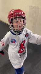 Young hockey player walks through hallway in Krasnoyarsk