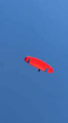Paragliders fill the sky over Kuta Selatan on a clear Bali morning