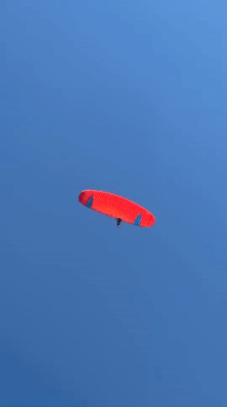 Paragliders fill the sky over Kuta Selatan on a clear Bali morning