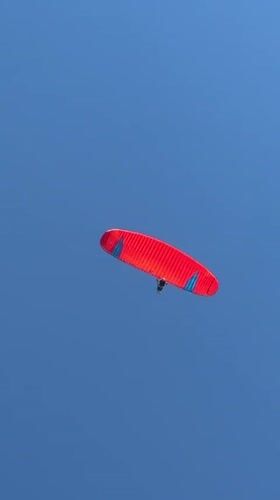 Paragliders fill the sky over Kuta Selatan on a clear Bali morning