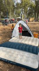 Girl jumps on air mattresses at Israeli camping ground