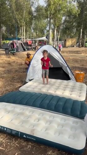 Girl jumps on air mattresses at Israeli camping ground