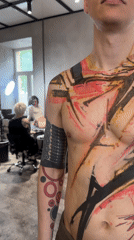 Abstract tattoo in red, yellow, black observed in Moscow
