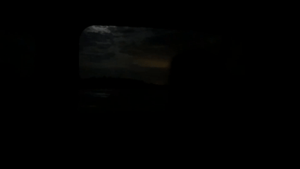 Moonlit water view captured through window in Sidorovy Gory