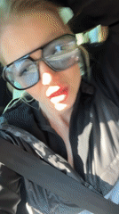Woman sings along to music while driving with child