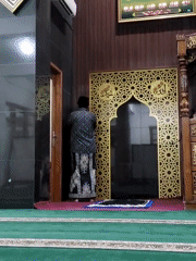 Prayer time at a mosque, with a few personal items on hand