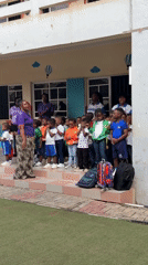 Elementary students gather in school courtyard with teachers