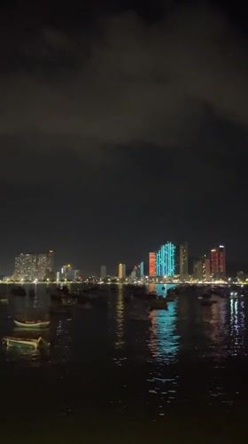 Nha Trang harbor life: fishing boats, basket boats, and city skyline