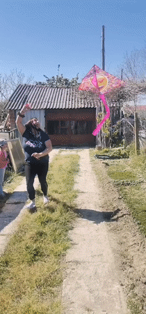 Woman, girl fly emoji kite in Bulgarian village