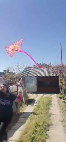 Woman, girl fly emoji kite in Bulgarian village