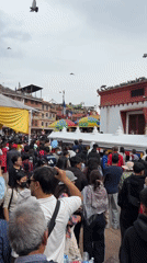 Crowds gather at Boudhanath Stupa in Kathmandu for morning prayers