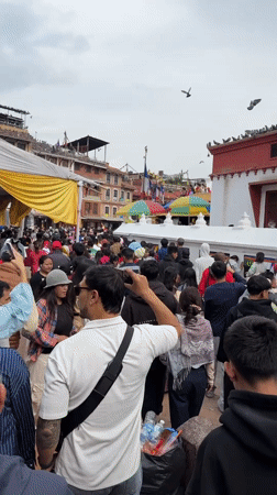 Crowds gather at Boudhanath Stupa in Kathmandu for morning prayers