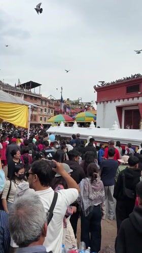 Crowds gather at Boudhanath Stupa in Kathmandu for morning prayers