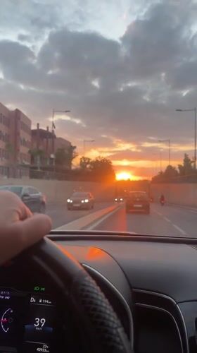 Driver navigates sunset traffic in Marrakesh, Morocco