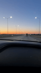 Dashboard camera captures evening highway traffic near Russian town