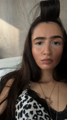 Woman takes selfies, portraits in London indoor setting