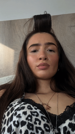 Woman takes selfies, portraits in London indoor setting