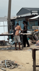 Men gather in commercial area, Ado Nigeria