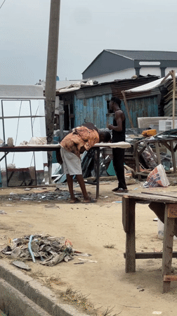 Men gather in commercial area, Ado Nigeria