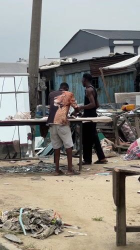Men gather in commercial area, Ado Nigeria