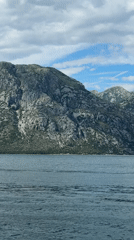 Small boats cross choppy bay waters near Prčanj, Montenegro