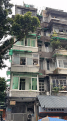 Old residential building with balcony gardens documented in Liwan District