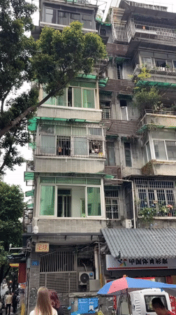 Old residential building with balcony gardens documented in Liwan District