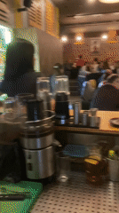 Restaurant bar area filmed showing equipment and crowd